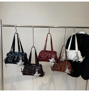 Detailed display of vintage glossy shoulder bags with star pendants and diverse colors
