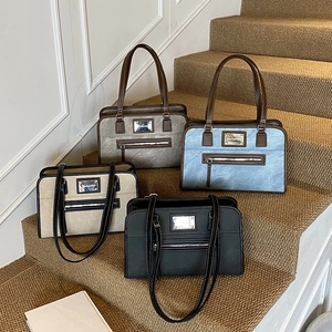 Trendy denim texture underarm bags in four colors on stairs for a stylish summer look