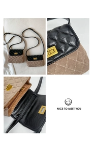 Detail view of contrast quilted flap bag with golden twist lock and interior storage