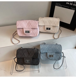 Detail of tweed quilted crossbody bags with chain straps in four different colors