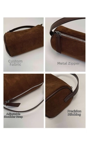 Close-up of brown suede cylinder bag showing silver zipper and premium stitching details