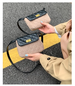 Detail of quilted leather patchwork bag with gold twist lock and elegant chain strap