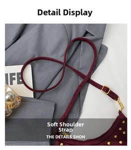 Detail of adjustable wine red suede strap with gold metal buckle and rivet accents
