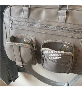 Dettaglio della borsa in tela multitasche con zip metalliche che mostra la capienza