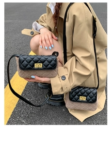 Detail of quilted two-tone crossbody bag with gold twist lock on khaki trench coat