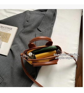 Interior view of yellow canvas tote bag showing space for phone, wallet and perfume