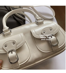 Close-up of cream shoulder bag with wrinkled texture PU leather and metal buckles