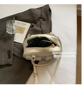 Interior view of the cream leather Boston bag showing spacious storage for smartphones