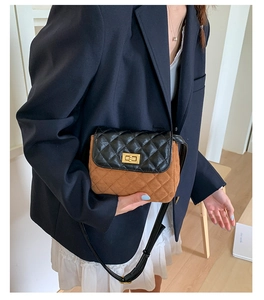 Detail of color-block quilted crossbody bag with gold-tone twist lock and strap