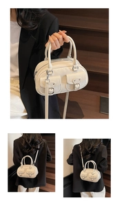 Detail view of white glossy PU bag featuring dual utility pockets and silver hardware