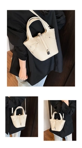 Détail du sac seau crème avec texture litchi, fermoir métallique et bandoulière réglable