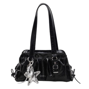 Minimalist black patent leather underarm bag with silver star charm and wrinkled texture