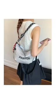 Detail of silver metallic crescent bag with Pantor lettering and rope shoulder strap