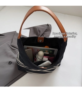 Spacious interior of striped nylon tote showing tablet, umbrella and wallet storage