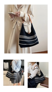 Detail of vintage nylon hobo bag with white stripes and brown leather handles