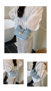 Detail view of light blue rhinestone hobo bag with silver buckle and metallic chain strap