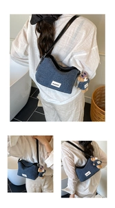 Detail of blue denim shoulder bag with leather trim and bear plush pendant accessory