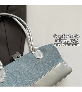 Detail of silver leather and blue-grey metallic fabric stitching on stylish handbag