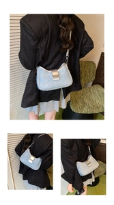 Detail of light blue sequined crescent bag with silver buckle and leather strap
