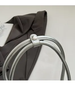 Close-up of premium silver leather handbag handle with high-quality metal hardware