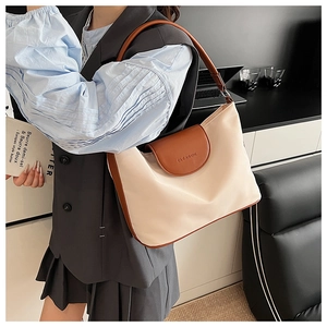 Detail of contrast stitching and embossed logo on minimalist ivory and brown tote bag