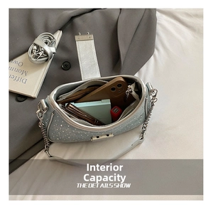 Detail view of the interior capacity of a denim rhinestone bag with a metal chain