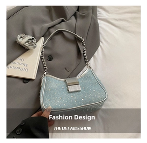 Macro detail of light blue rhinestone handbag with silver metal buckle and chain handle