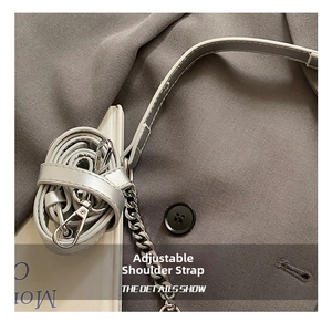 Detail of adjustable silver leather and metal chain shoulder strap with lobster clasp