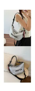 Detail of silver quilted crossbody bag with black braided strap and heart pendant