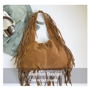 Close-up of brown suede hobo bag with fringe details on a white background scene