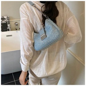 Detail of light blue crystal shoulder bag with rhinestone texture and metal chain