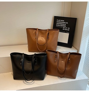 Three large leather tote bags in black, dark coffee and camel shown in tiered layout