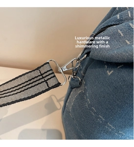 Close-up of durable silver metal buckle and striped woven strap on blue denim tote bag