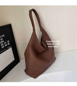 Detail of vintage brown woven hobo bag showing high-quality texture and soft leather