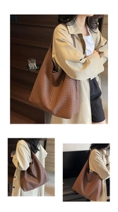 Detailed view of the dark brown leather woven texture on a spacious tote bag