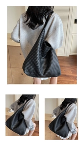 Close-up of black woven leather tote bag texture and spacious minimalist design