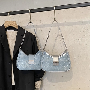 Sparkly light blue sequin underarm bag with silver chain strap and metal buckle detail