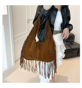 Detail of bohemian dark brown suede hobo bag featuring long tassels and large capacity