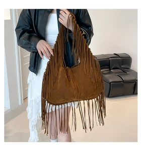 Detail of vintage brown suede tote bag featuring extra long fringe bohemian style design