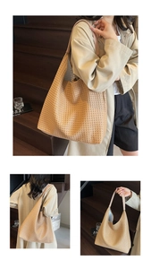 Detailed close-up of woven tote bag texture with leather shoulder strap and spacious interior
