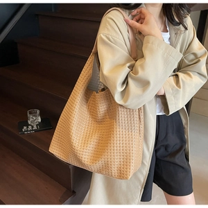 Detail of light brown woven tote bag showing dense texture and high-quality craftsmanship