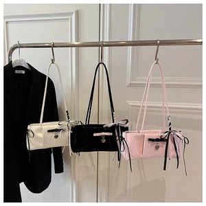 Chic shoulder bags with bow details and heart charms in white, black, and pink colors