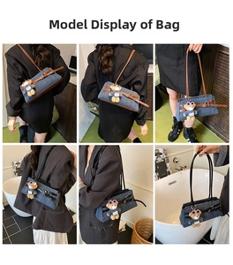 Detail of denim patchwork tote bag with leather buckle strap and teddy bear charm