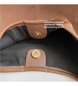 Close-up of magnetic snap closure and dark fabric lining on a brown tote bag