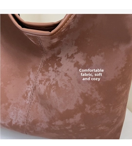 Macro detail of the brown matte suede tote bag showing texture and vertical stitching