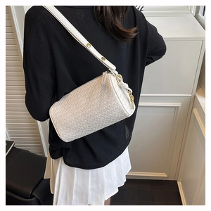 Detailed view of white woven leather pillow bag with gold metal buckle and knotted strap