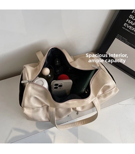 Inside view of an open cream tote bag showing phone, umbrella, and water bottle storage