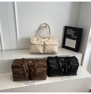 Three travel tote bags in cream, brown, and black colors displayed on stylish steps