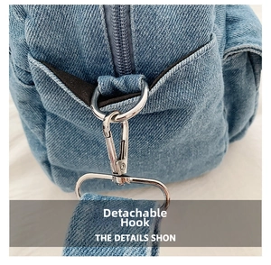 Detail of silver detachable hook and denim strap on a retro crossbody square bag