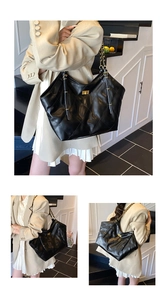 Macro shot of quilted black chain tote bag showing large capacity and golden twist lock